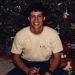 Me by a Christmas tree with a drink, 1988