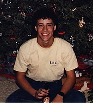 Me by a Christmas tree with a drink, 1988