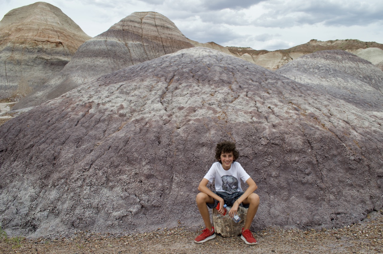 Julian sits on a petrified stump.