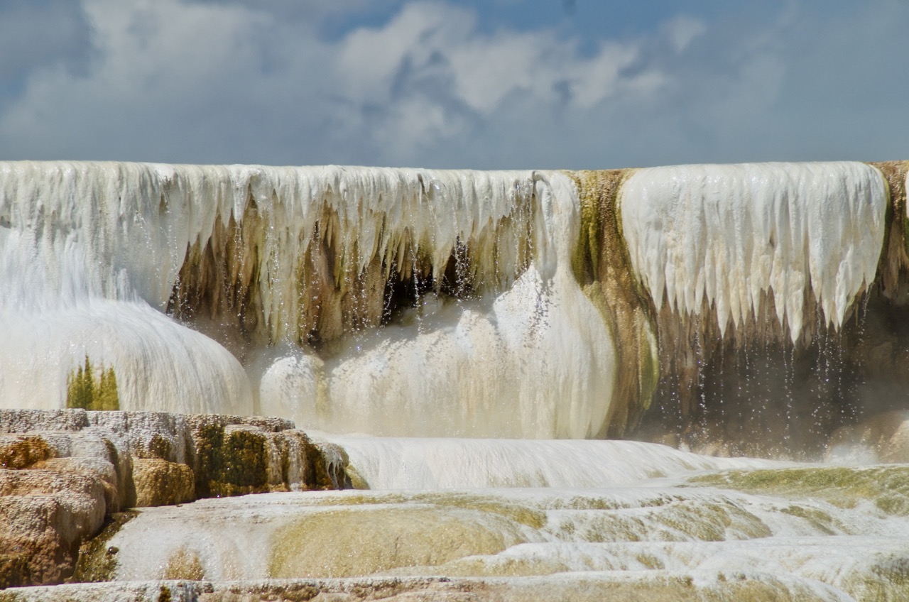 Stalactite-like formations drip over the top edge of Mammoth Hot Springs.