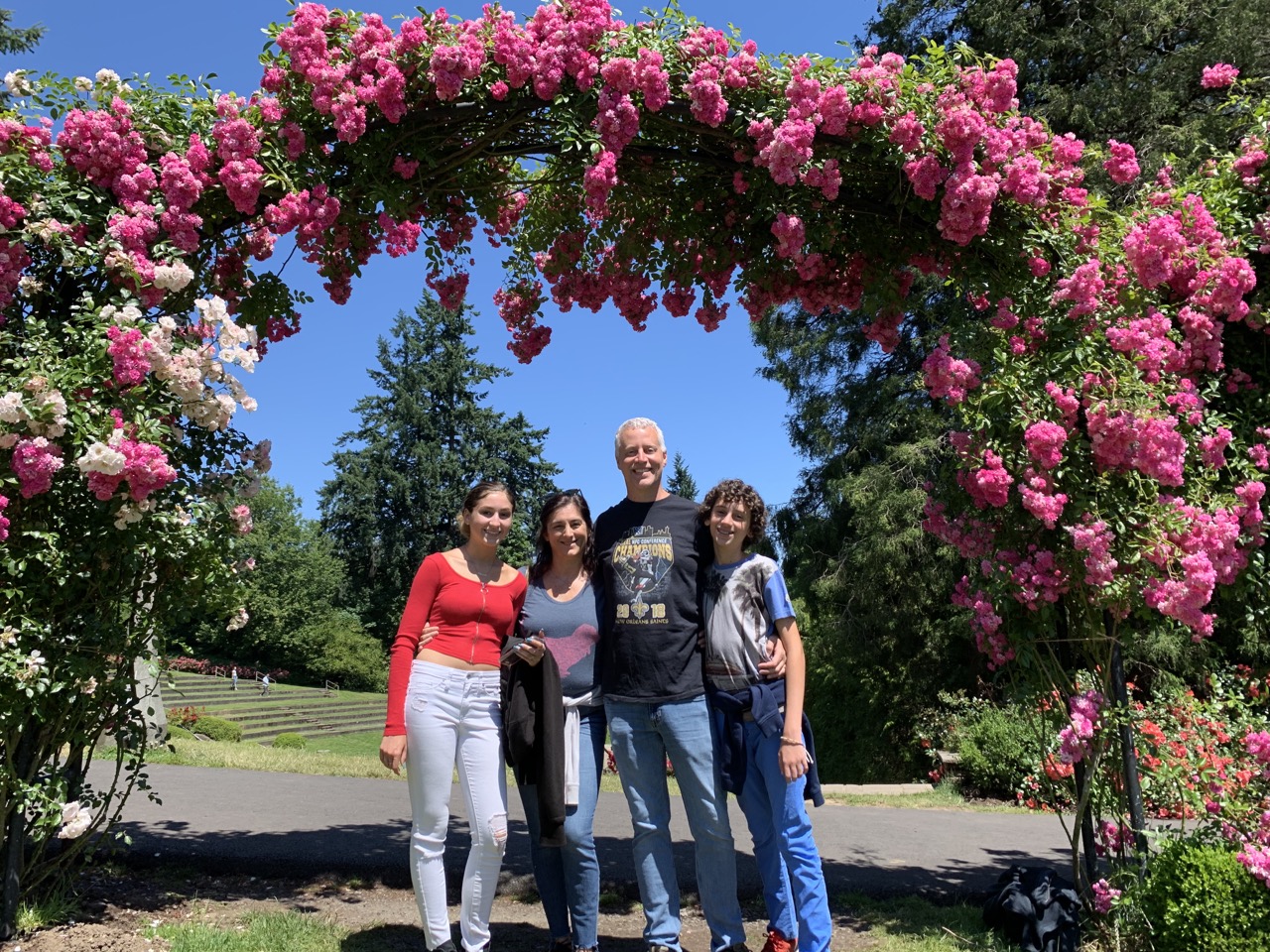 The family under an arch of roses.