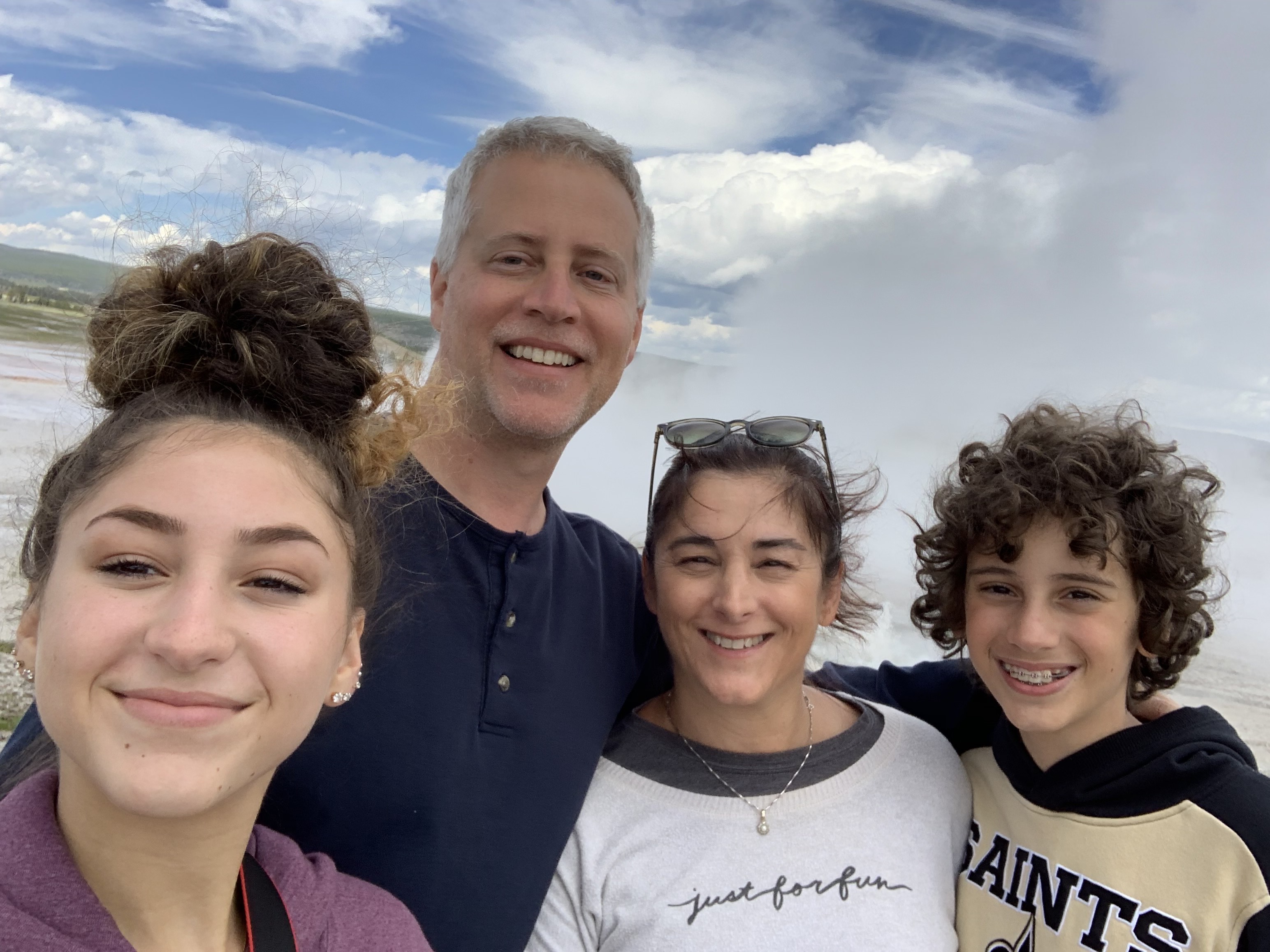 Steam rising behind the family in Yellowstone National Park.