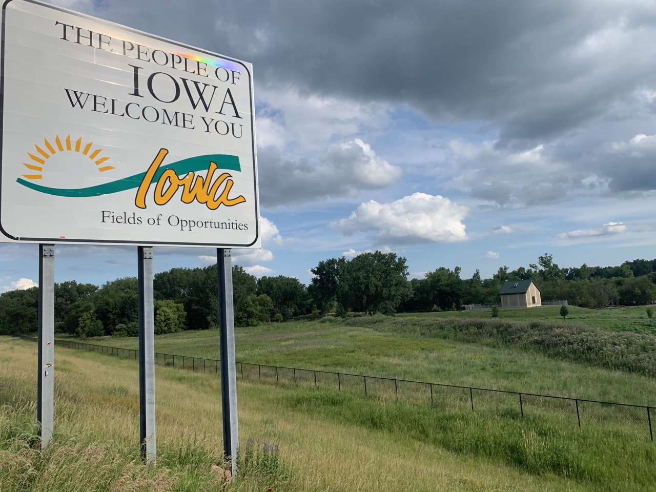 Iowa State Welcome Sign. The states are flying past us.