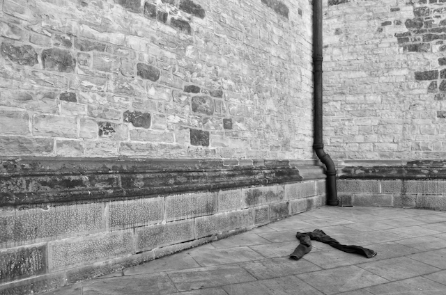 Discarded jeans near an empty alleyway